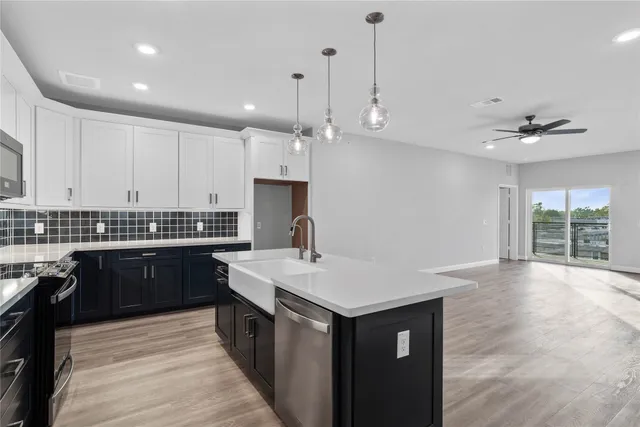 a kitchen with a sink stove and cabinets