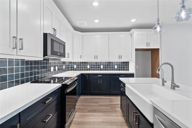 a kitchen with a sink a stove and cabinets