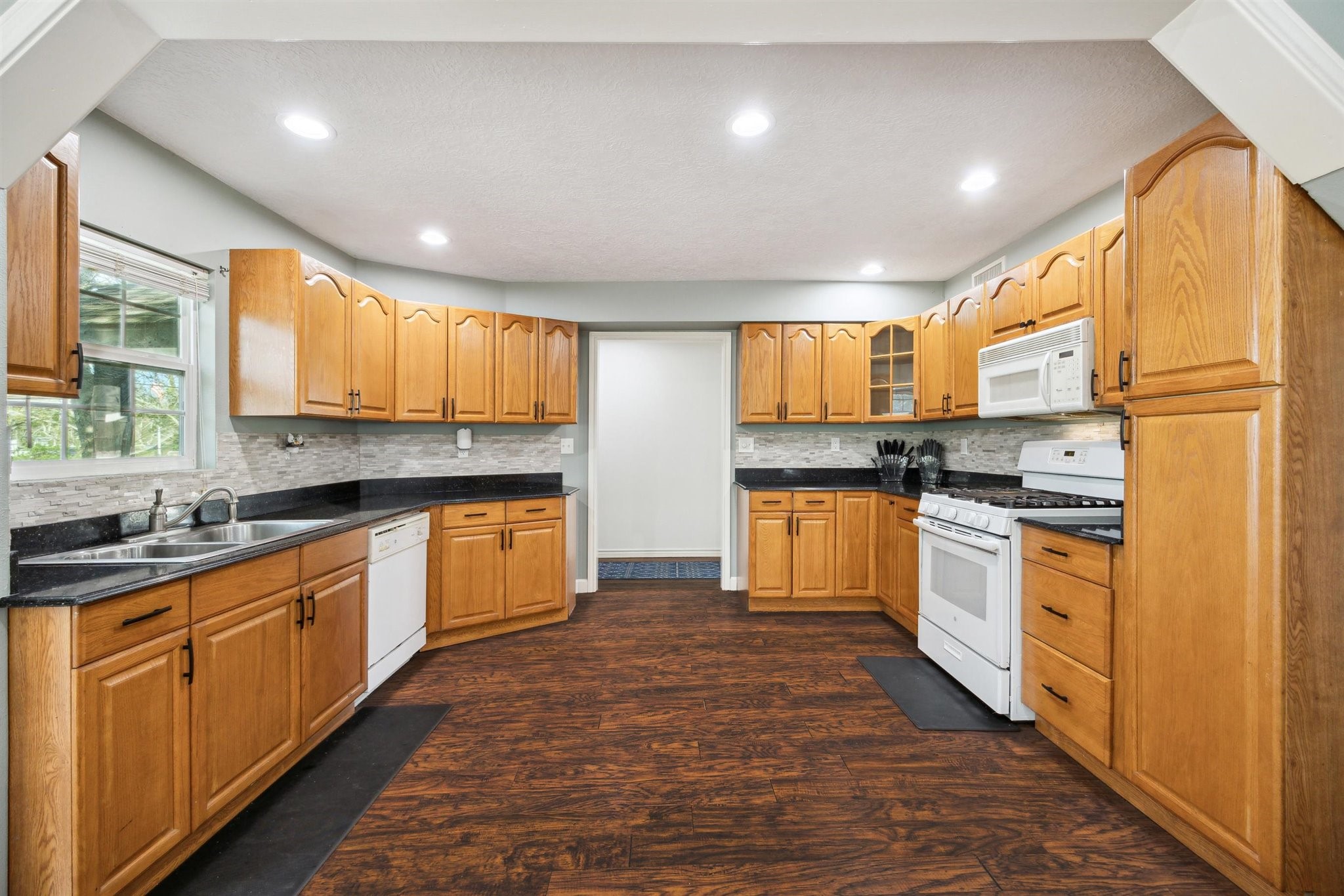 3702 Chanterway Street Bacliff, TX 77518 - Photo 2 of 19 a kitchen with granite countertop a refrigerator sink and cabinets