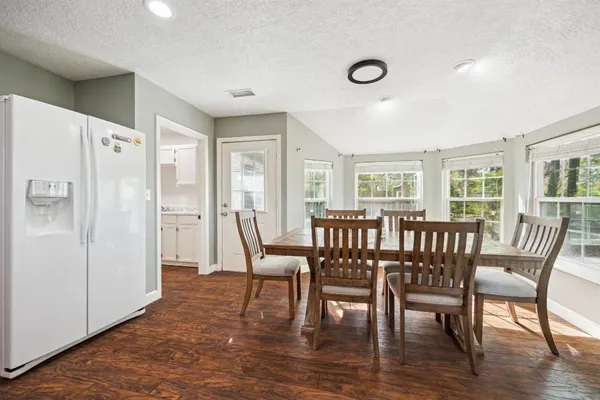 a dining room with furniture and window