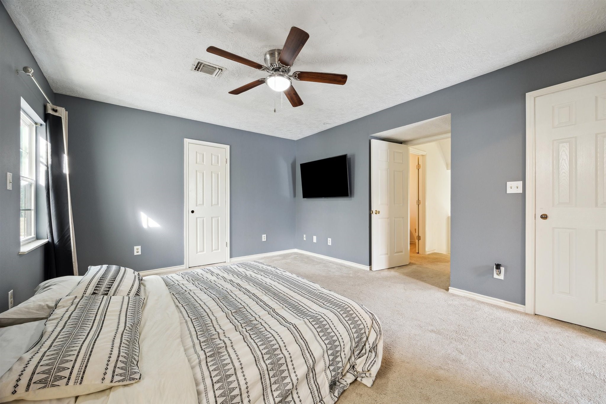 3702 Chanterway Street Bacliff, TX 77518 - Photo 10 of 19 a bedroom with a large bed and a flat screen tv