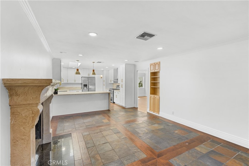 26096 Adamor Road Calabasas, CA 91302 - Photo 19 of 61 Family room looking back towards kitchen. Cabinets built into the wall and a glass pocket door separates the living room and dining room area for excellent noise privacy.