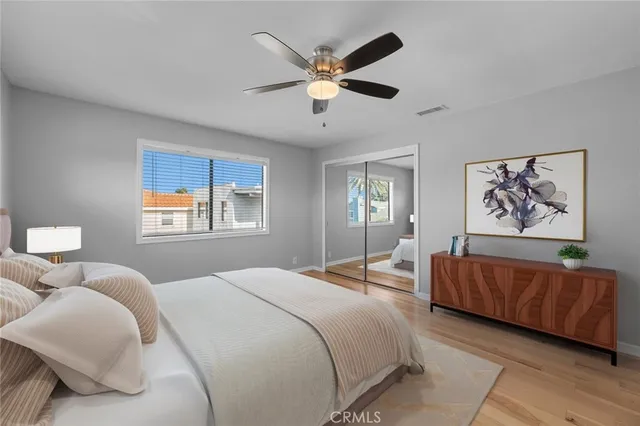 a bedroom with a large bed and a chandelier