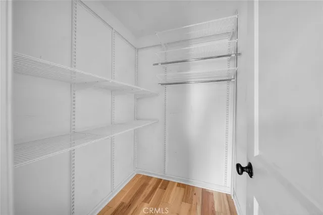 a view of a balcony with wooden floor and potted plants