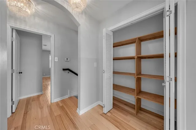 a view of a room with rack on the wall and a window