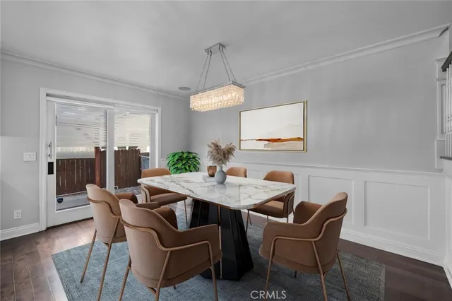 a living room with furniture a chandelier and a potted plant