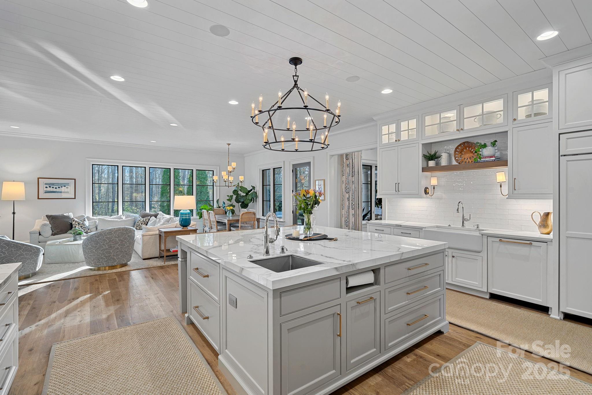 19117 Davidson-Concord Road Davidson, NC 28036 - Photo 11 of 48 a large white kitchen with a large island oven a sink stainless steel appliances and cabinets