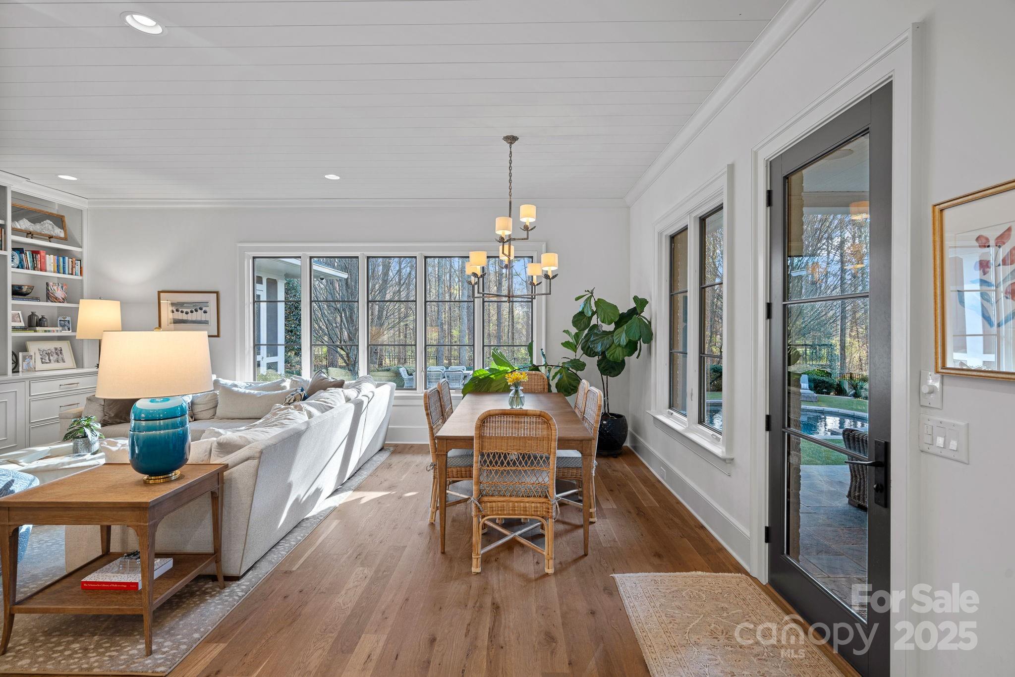 19117 Davidson-Concord Road Davidson, NC 28036 - Photo 12 of 48 a living room with furniture and a chandelier