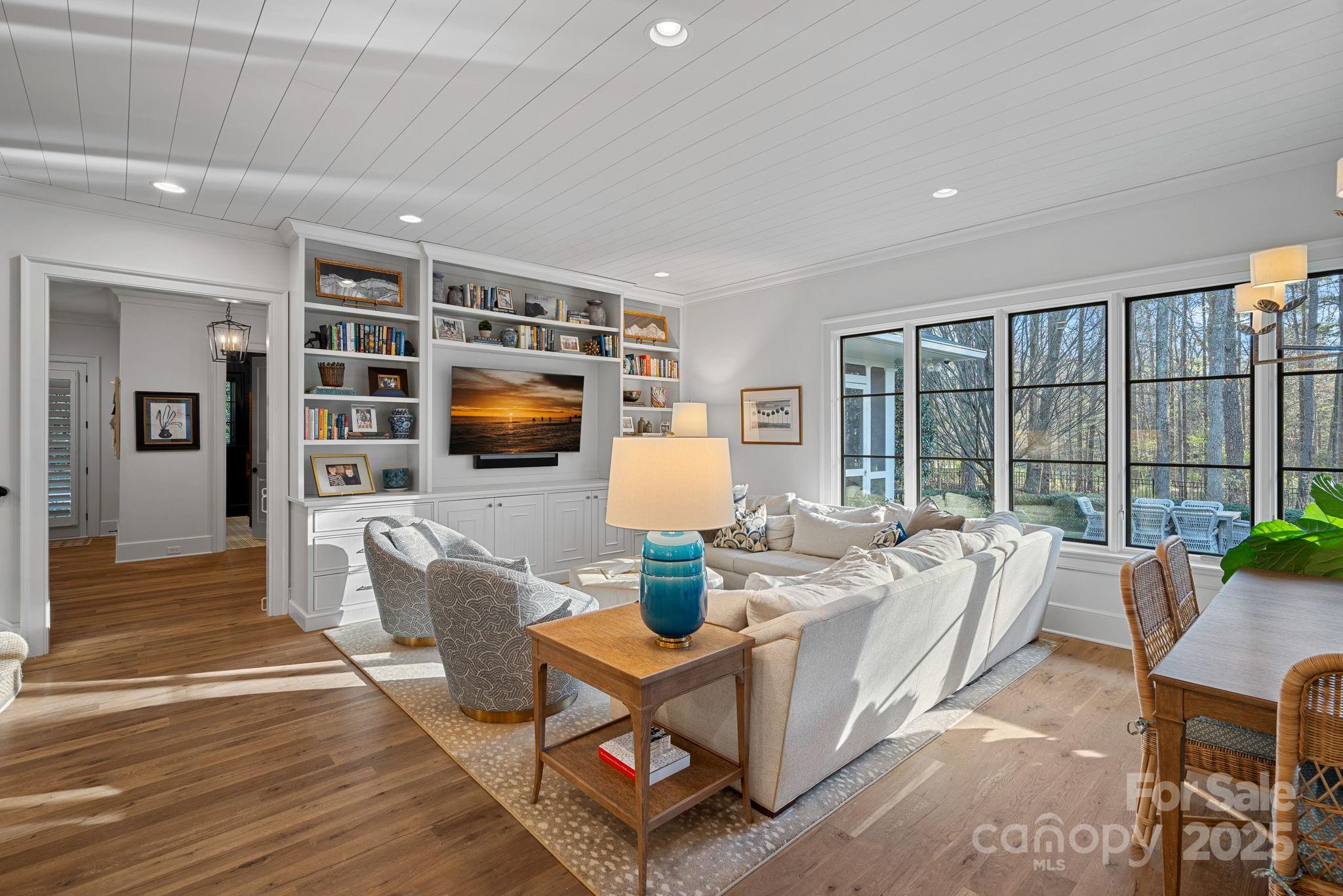 19117 Davidson-Concord Road Davidson, NC 28036 - Photo 13 of 48 a living room with furniture and a flat screen tv