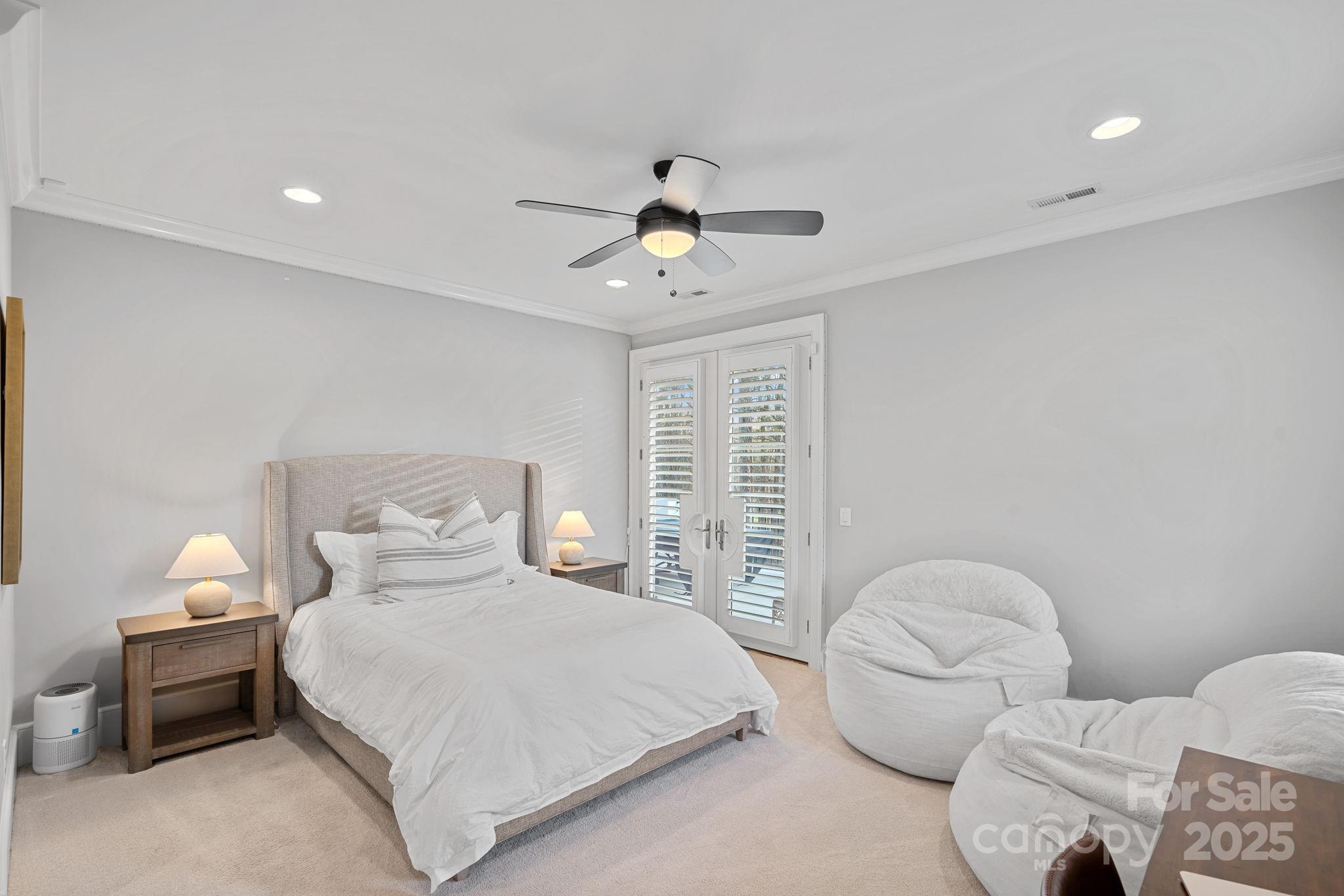 19117 Davidson-Concord Road Davidson, NC 28036 - Photo 27 of 48 a bedroom with a bed and a chandelier