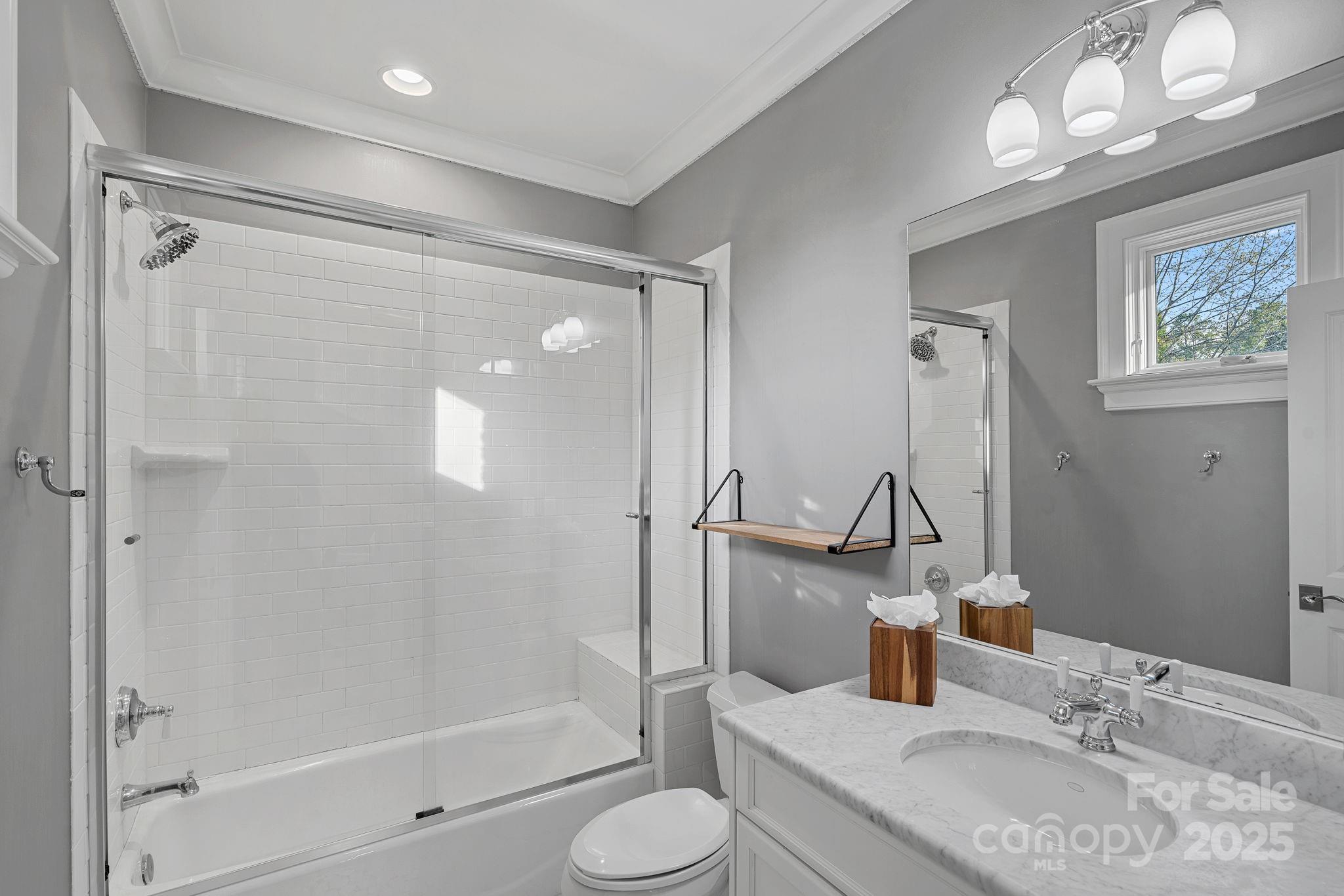 19117 Davidson-Concord Road Davidson, NC 28036 - Photo 28 of 48 a bathroom with a granite countertop sink toilet and shower