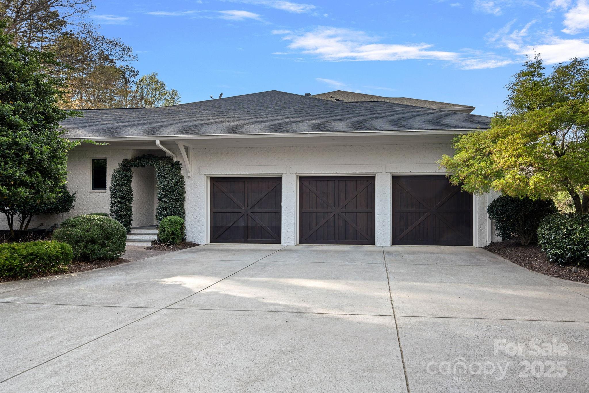 19117 Davidson-Concord Road Davidson, NC 28036 - Photo 45 of 48 a front view of a house with a yard and garage