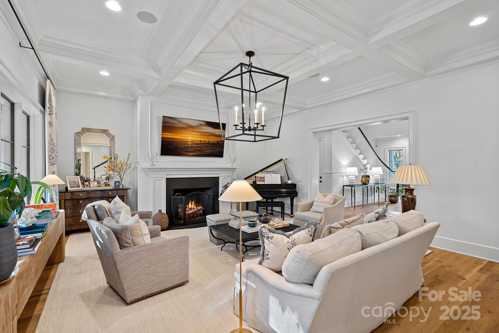 19117 Davidson-Concord Road Davidson, NC 28036 - Photo 8 of 48 a living room with furniture a fireplace and a flat screen tv