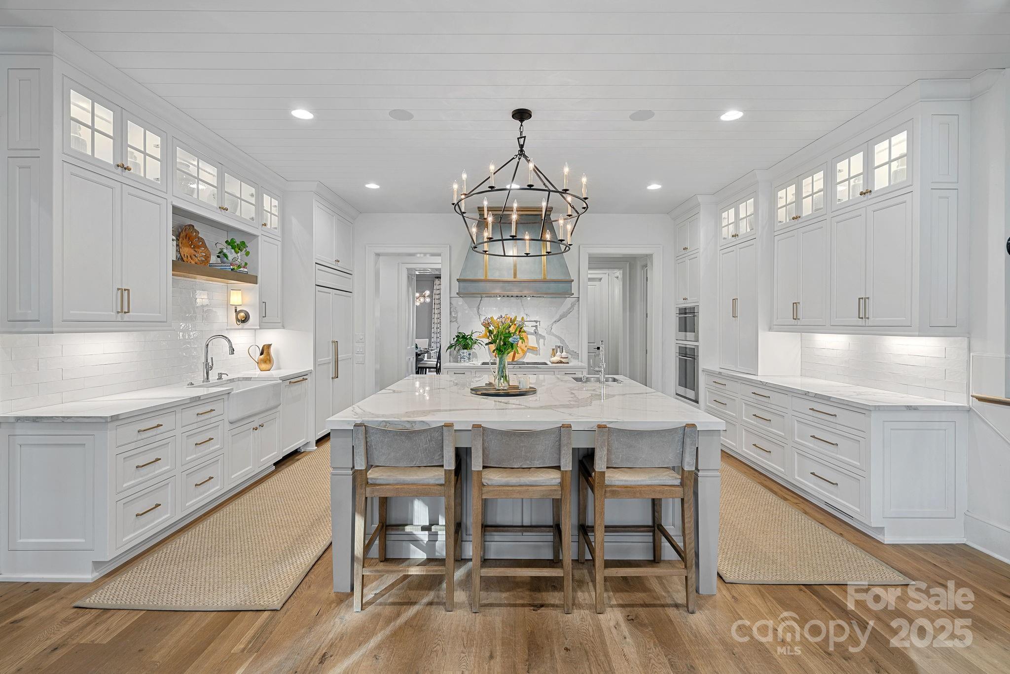 19117 Davidson-Concord Road Davidson, NC 28036 - Photo 9 of 48 a large kitchen with kitchen island a dining table and chairs