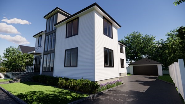 a front view of a house with garage and plants