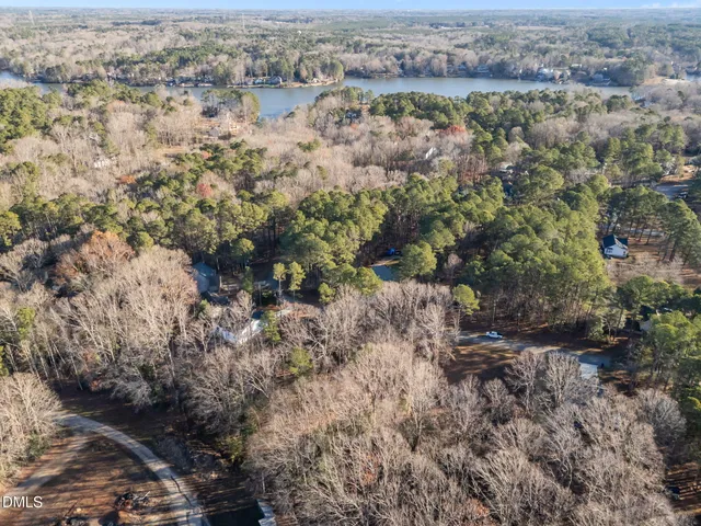 an aerial view of house with yard and mountain view in back
