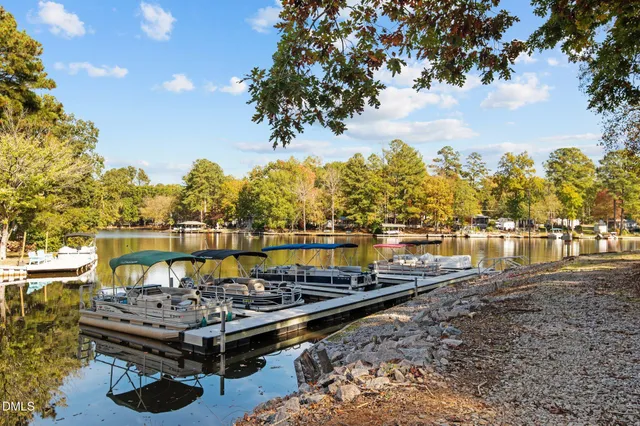a view of a lake with boats and trees in the background