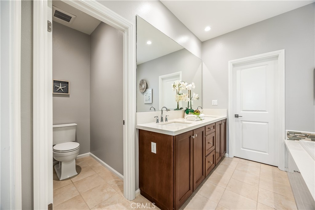 51 Decker Irvine, CA 92620 - Photo 29 of 49 a bathroom with a granite countertop sink toilet and mirror