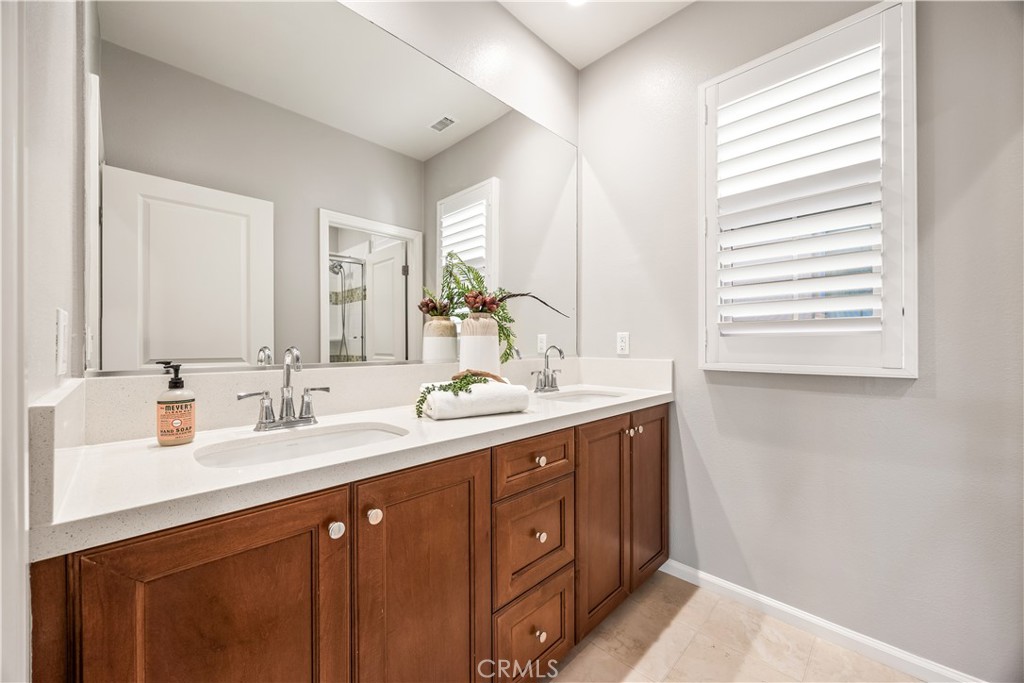 51 Decker Irvine, CA 92620 - Photo 30 of 49 a bathroom with a double vanity sink and a mirror