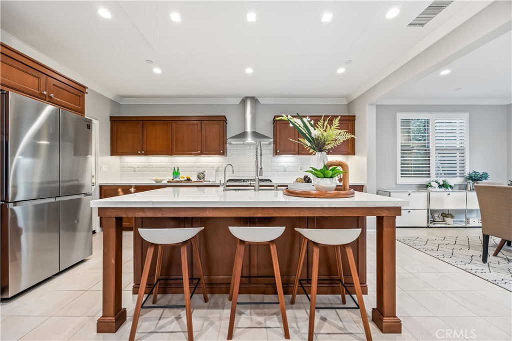 51 Decker Irvine, CA 92620 - Photo 6 of 49 a kitchen with stainless steel appliances granite countertop a table chairs refrigerator and sink