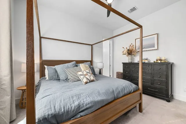 a bedroom with a bed and cabinet