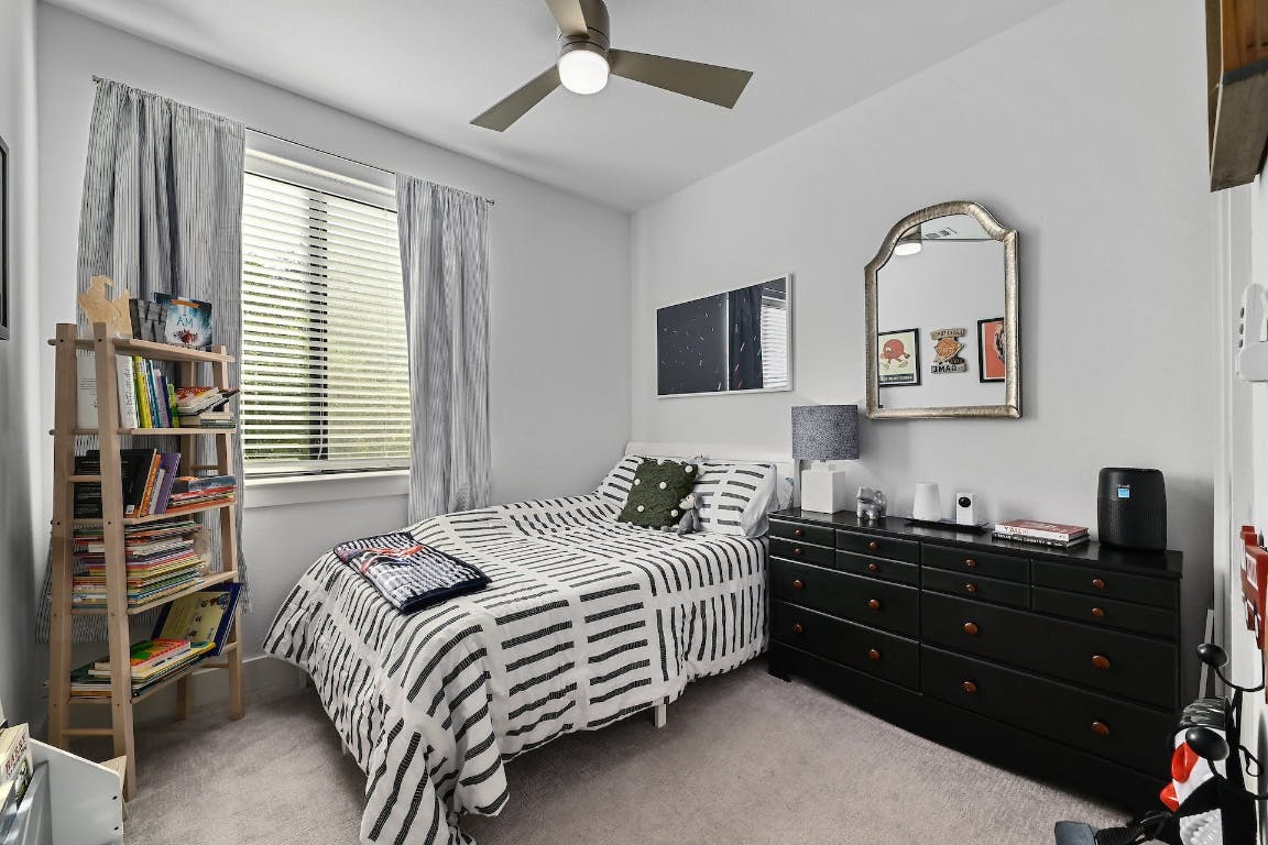 2050 Lohmans Spur Road, Unit 2301 Lakeway, TX 78734 - Photo 18 of 27 a bedroom with a bed and a television