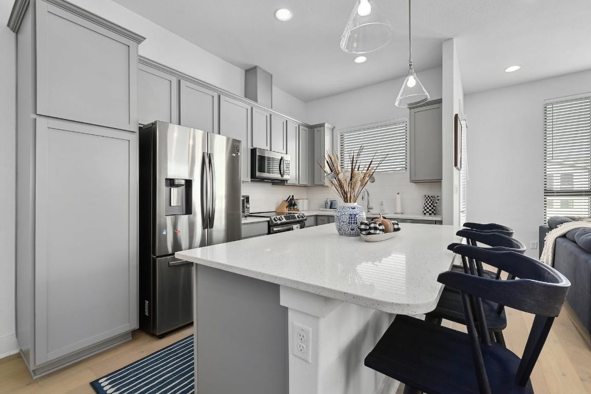 2050 Lohmans Spur Road, Unit 2301 Lakeway, TX 78734 - Photo 8 of 27 a kitchen with refrigerator a sink and a stove