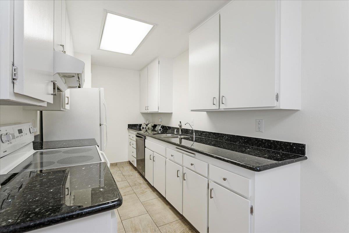 1416 Dolphin Drive Aptos, CA 95003 - Photo 15 of 40 a kitchen with granite countertop white cabinets and stainless steel appliances