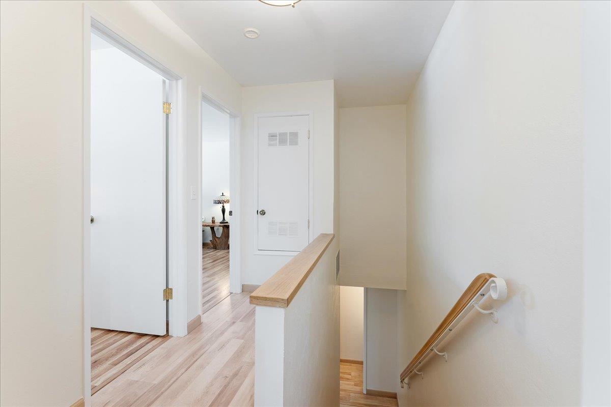 1416 Dolphin Drive Aptos, CA 95003 - Photo 19 of 40 a view of a hallway with wooden floor and staircase