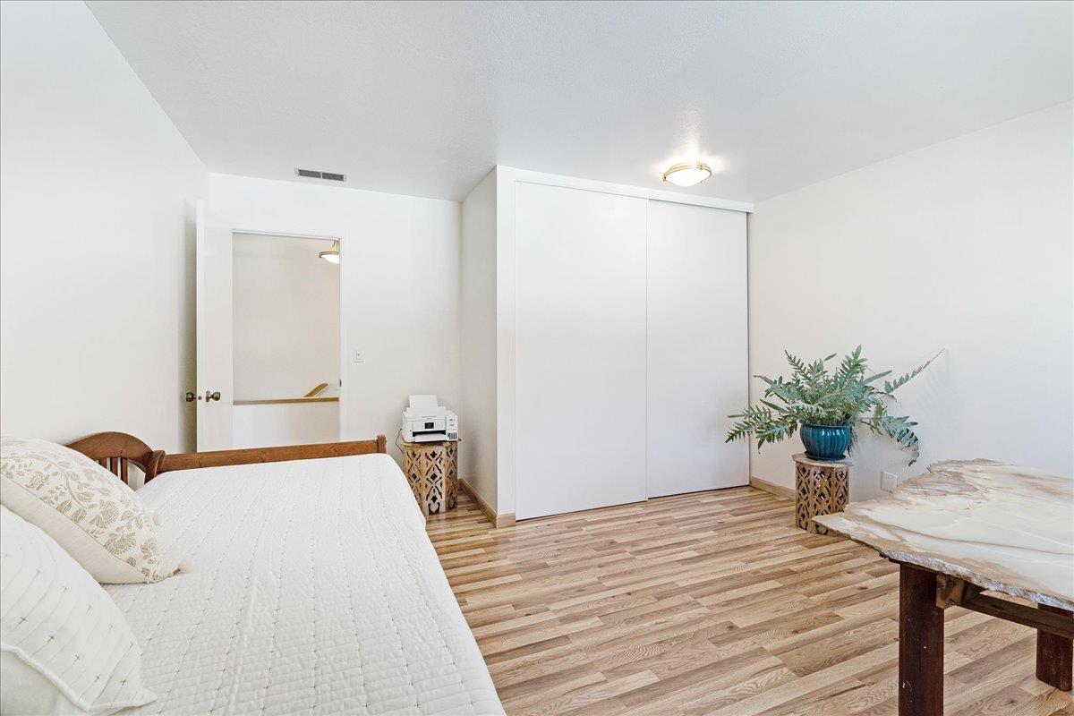 1416 Dolphin Drive Aptos, CA 95003 - Photo 22 of 40 a bedroom with a bed and a potted plant