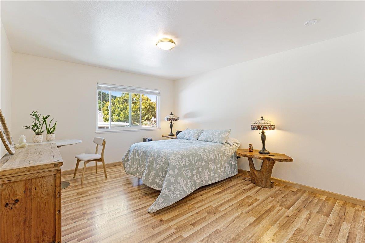 1416 Dolphin Drive Aptos, CA 95003 - Photo 24 of 40 a bedroom with a bed and wooden floor