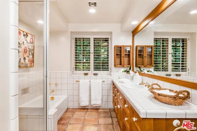 a bathroom with a tub sink and window