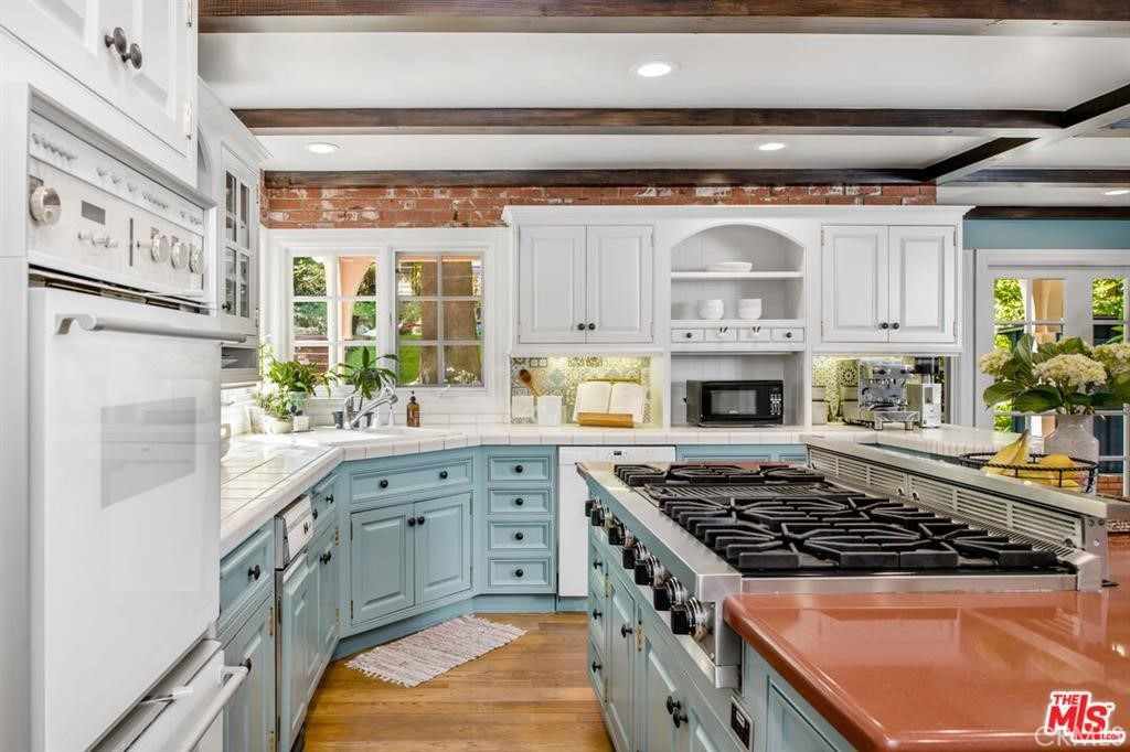 5255 Round Meadow Road Hidden Hills, CA 91302 - Photo 5 of 18 a kitchen with stainless steel appliances granite countertop a stove and a sink