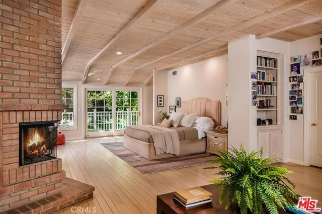a living room with furniture fireplace and flat screen tv