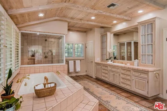 a spacious bathroom with a large tub and shower