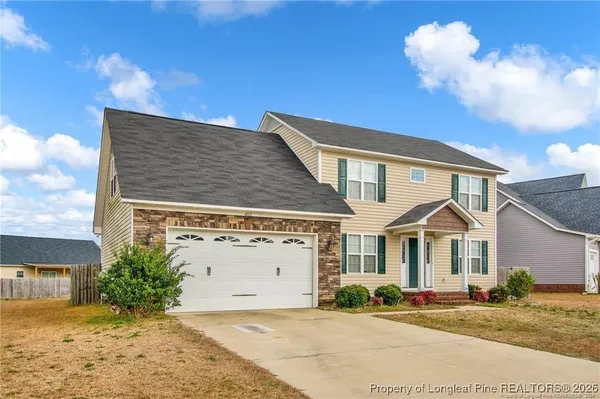 a view of a house with a yard