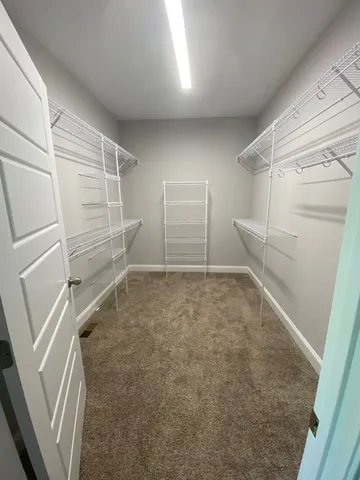 a white toilet sitting next to a shower