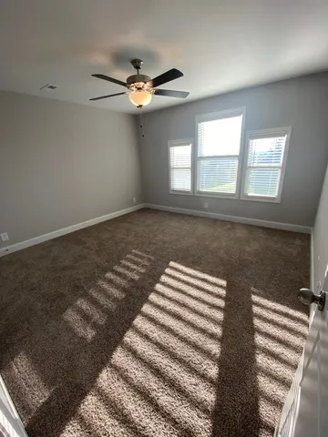 an empty room with a wooden door and door