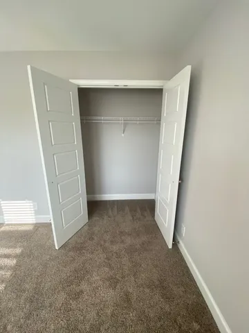 a view of an empty room with a ceiling fan