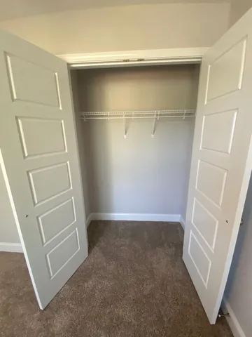 en empty room with windows and fan