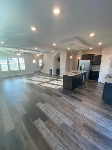 a view of a large kitchen with a table and chairs