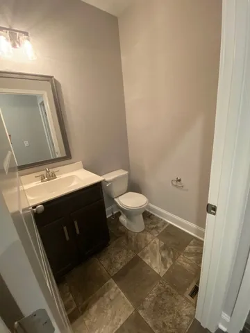 an empty room with windows and chandelier fan