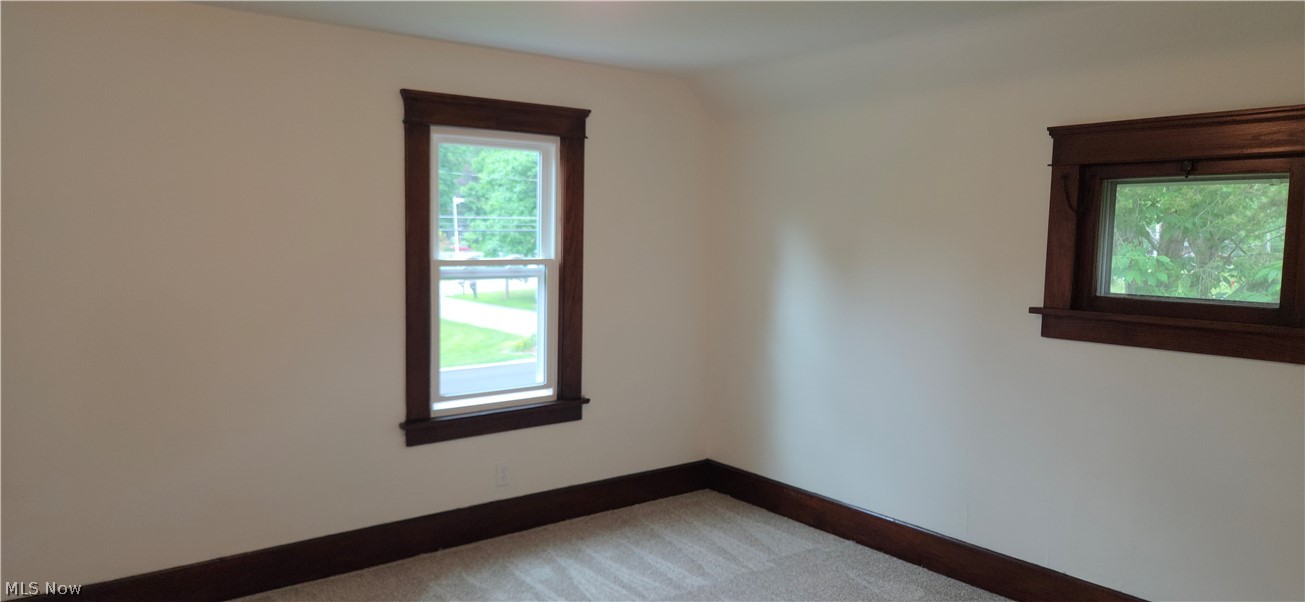 9964 East River Road Elyria, OH 44035 - Photo 21 of 45 Neutral-toned walls complement rich wood-finish trim, offering a versatile aesthetic. Fresh paint, new carpet.