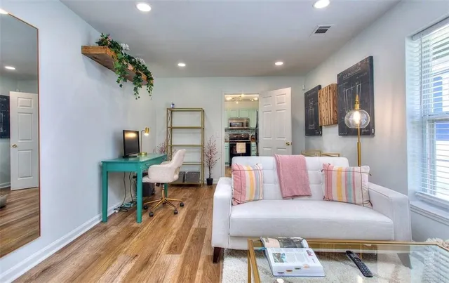 a living room with furniture and wooden floor