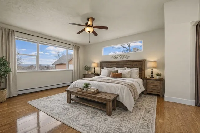 a bathroom with a granite countertop sink a toilet and shower