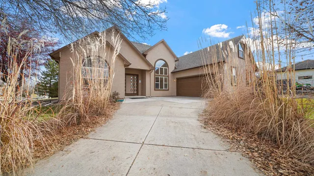 a view of a hallway with wooden floor and a potted plant