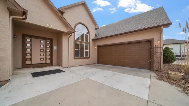 a living room with furniture a fireplace and a chandelier