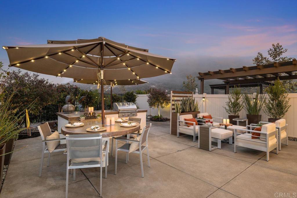 3110 Simba Way Carlsbad, CA 92010 - Photo 1 of 1 a view of a patio with table and chairs under an umbrella