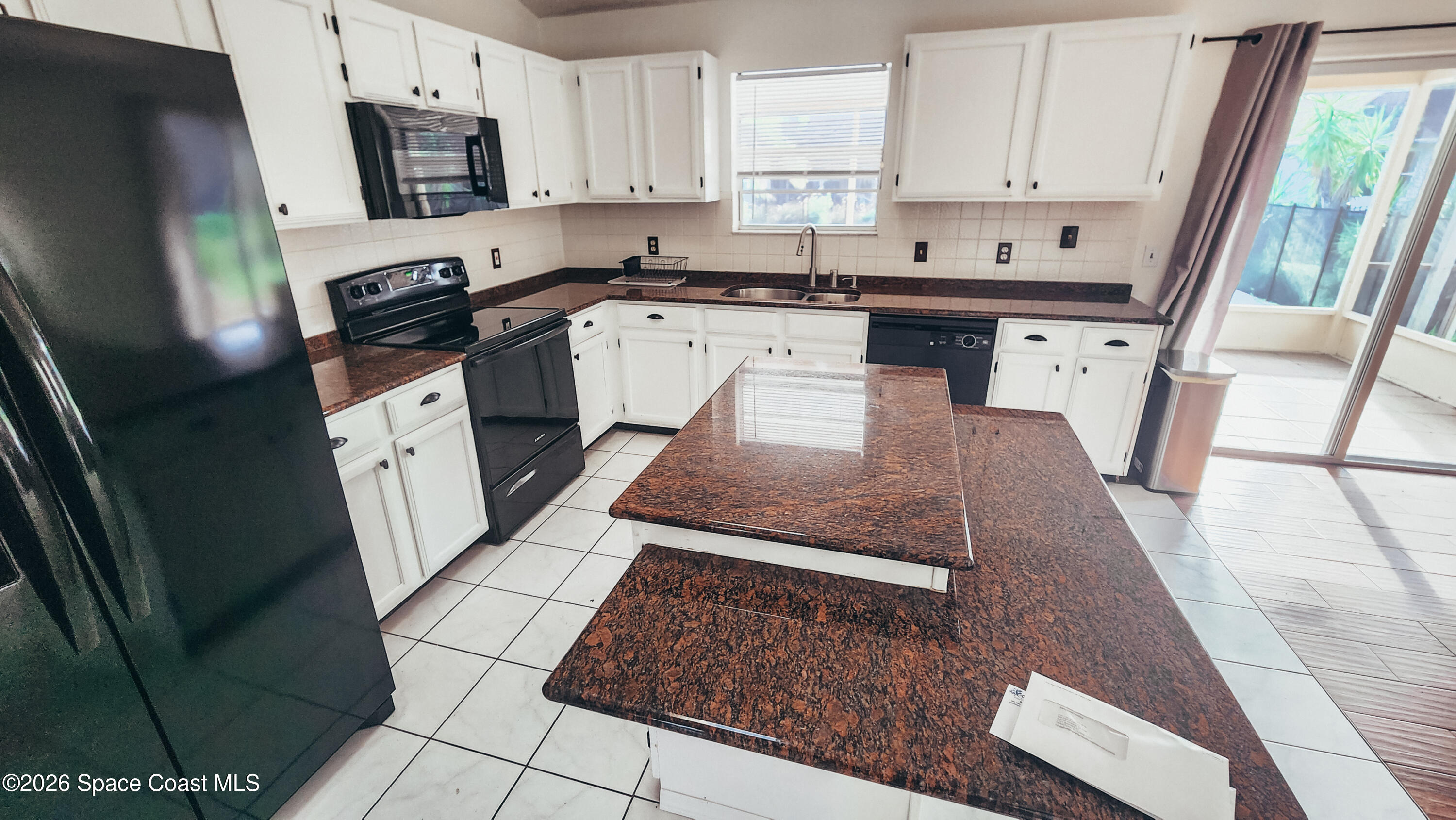 1521 Barber Street Sebastian, FL 32958 - Photo 14 of 33 a large kitchen with white cabinets