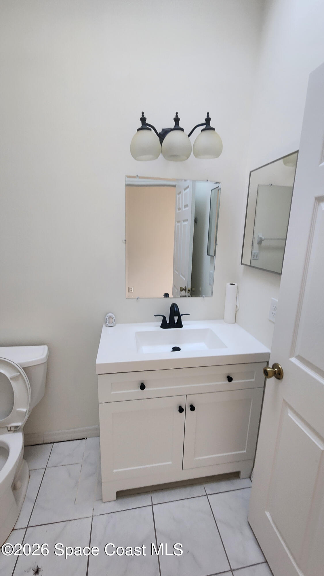 1521 Barber Street Sebastian, FL 32958 - Photo 16 of 33 a bathroom with a sink and a mirror